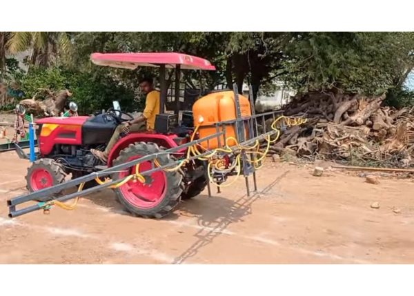 Murshid Farm Industries Implement Boom Sprayer attached to tractor, ready for spray.