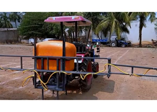 Murshid Farm Industries Implement Boom Sprayer attached to tractor, rear view.