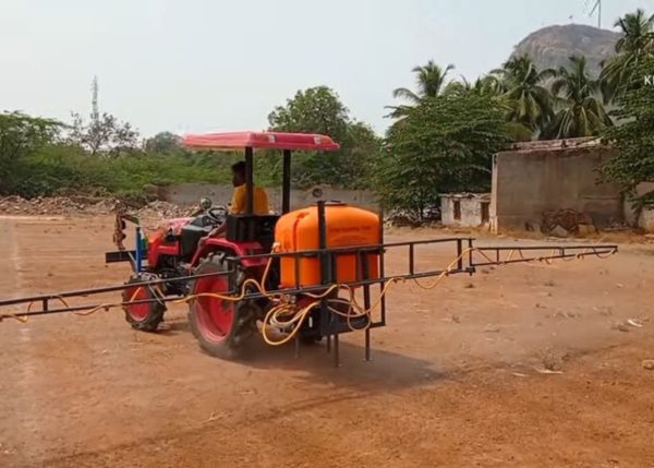 Murshid Farm Industries Implement Boom Sprayer attached to the back of a tractor, seen from a full view.