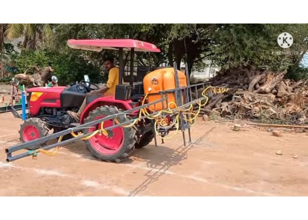 A Murshid Farm Industries Implement Boom Sprayer attached and lifted by a tractor.