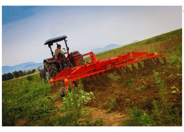 A Murshid Farm Industries Hydraulic Disc Harrow with 24 Discs in action, cultivating the field efficiently.