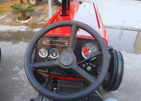 Close-up view of the Massey Ferguson Tractor MF-375 steering wheel and speedometer, showcasing precision engineering.