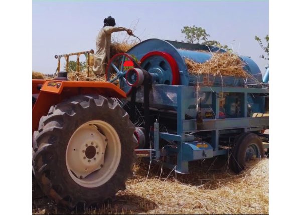 Murshid Farm Industries Implement Wheat Thresher in side angle view, working position, preparing wheat.