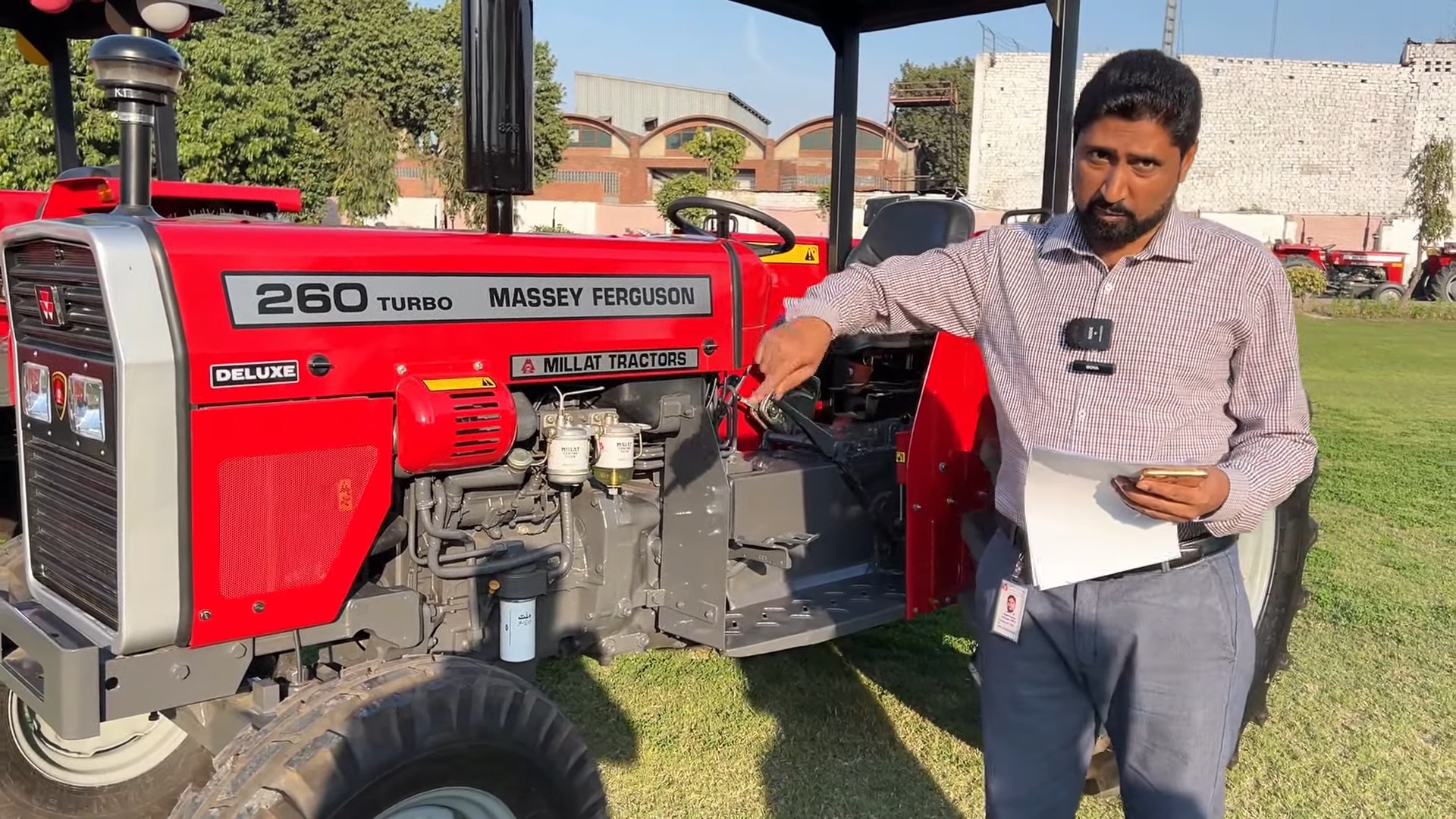 A brand-new Massey Ferguson MF 260 Deluxe tractor, showcasing its upgraded hydrostatic power steering and enhanced front design, parked in a sunny field.