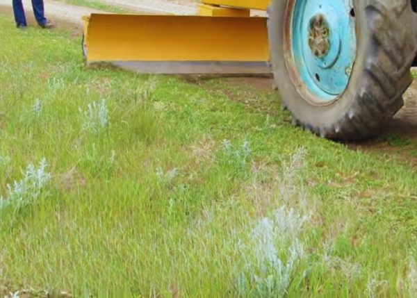 A front view of a Multi-Purpose Rear Blade attached to a tractor by Murshid Farm Industries Implement.