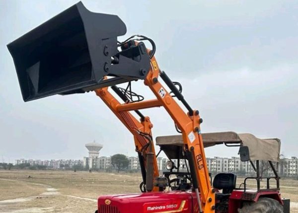 Murshid Farm Industries Implement HYDRAULIC FRONT END LOADER attached with tractor unloading position.