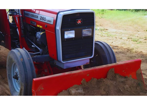 Murshid Farm Industries Implement HYDRAULIC FRONT BLADE attached to tractor working in farm land.