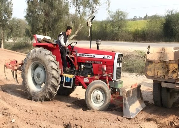 Murshid Farm Industries Implement HYDRAULIC FRONT BLADE attached with tractor working in the field.