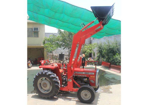 Murshid Farm Industries Implement HYDRAULIC FRONT END LOADER lifting a load on a farm.