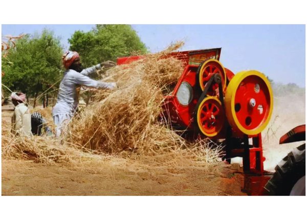 Murshid Farm Industries Implement Wheat Thresher in action on a farm field.