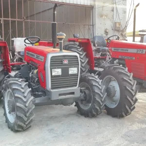 Massey Ferguson MF 360 Turbo 4WD 60HP tractor manufactured by Millat Tractors Pakistan, shown parked alongside Massey Ferguson MF 375 tractor in a factory yard