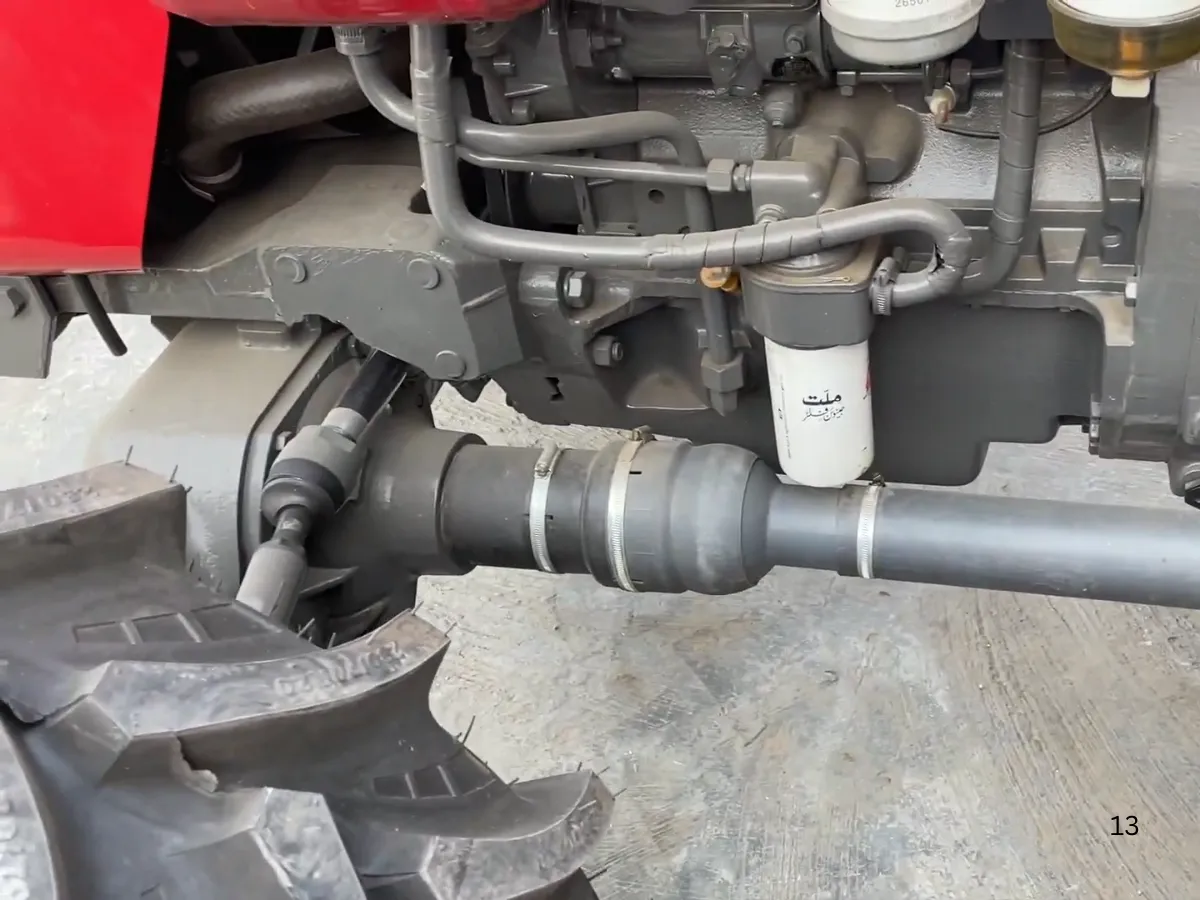 Massey Ferguson MF 360 Turbo 4WD 60HP tractor manufactured by Millat Tractors Pakistan, showing front axle, 4WD driveshaft, engine underside, and filter assembly