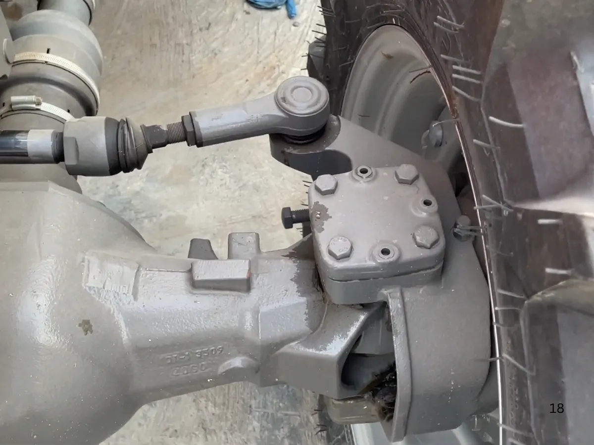 Massey Ferguson MF 360 Turbo 4WD 60HP tractor manufactured by Millat Tractors Pakistan, showing front axle knuckle, steering joint, and wheel hub assembly