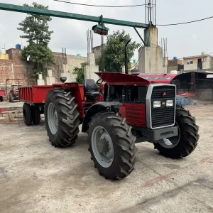 Millat Massey Ferguson MF 385 4WD 85 HP tractor standing in outdoor factory yard with tipping trailer attached