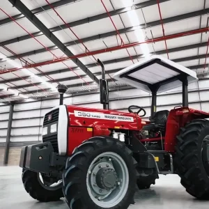 Millat Massey Ferguson MF 360 4WD 60 HP tractor standing inside warehouse with canopy and heavy-duty tyres