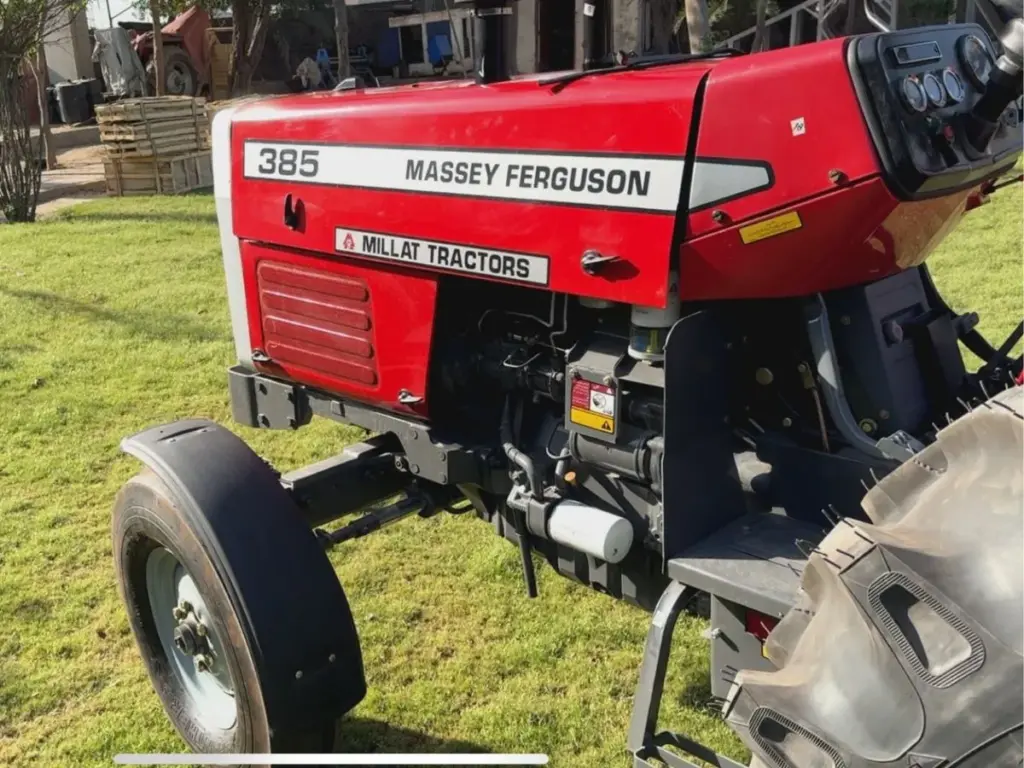 MF 385 2WD model and engine detail MF 385 model badge, engine area and narrow front tyre in a close side view