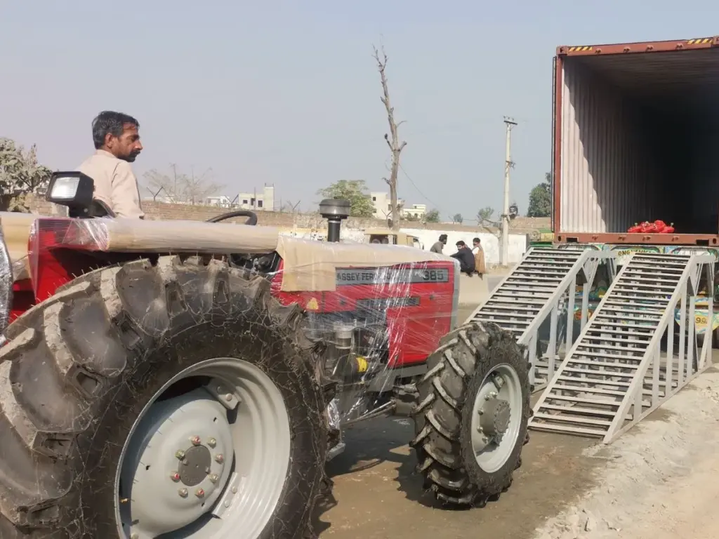 MF 385 4WD prepared near a container MF 385 4WD with protective wrapping next to container loading ramps