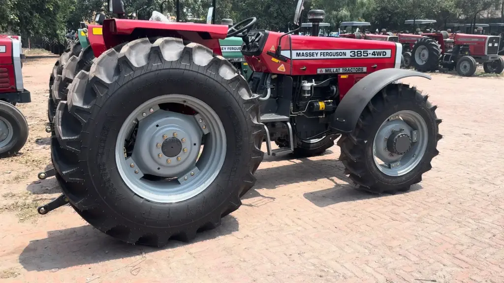 Side view of a red Massey Ferguson MF 385 4WD with large treaded front tyres