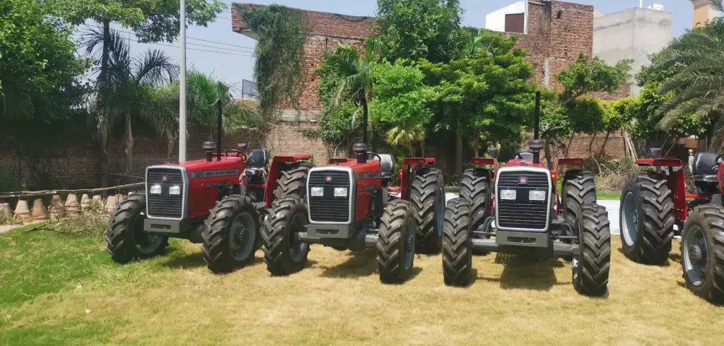 Front view of the MFI tractor lineup Several red Massey Ferguson tractors viewed from the front on a lawn